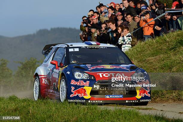 Sebastien Loeb of France and Daniel Elena of Monaco compete in their Citroen Total WRT Citroen DS3 WRC during Day Two of the WRC France on October...