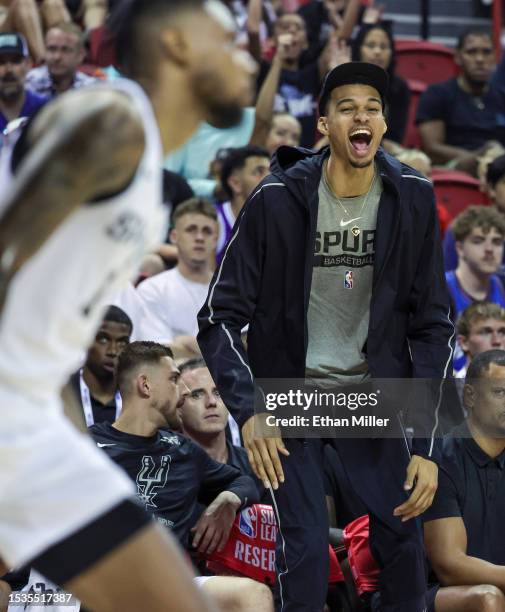 Victor Wembanyama of the San Antonio Spurs reacts on the bench after his teammate Blake Wesley dunked against the Washington Wizards in the second...