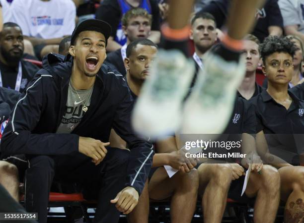 Victor Wembanyama of the San Antonio Spurs reacts on the bench as his teammate Blake Wesley dunks against the Washington Wizards in the second half...