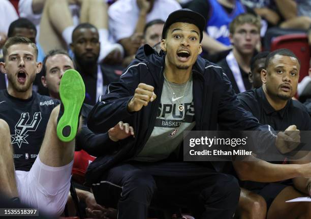 Erik Stevenson and Victor Wembanyama of the San Antonio Spurs react on the bench after the Spurs scored against the Washington Wizards in the second...