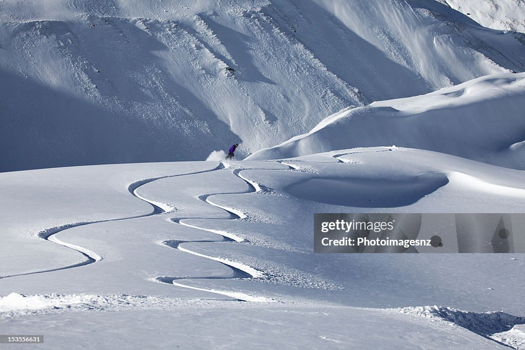 Snow Boarder in fresh powder, New Zealand