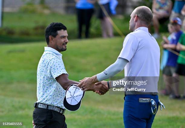 Fabian Gomez of Argentina greets Jared Wolfe after the final round of the Memorial Health Championship presented by LRS at Panther Creek Country Club...