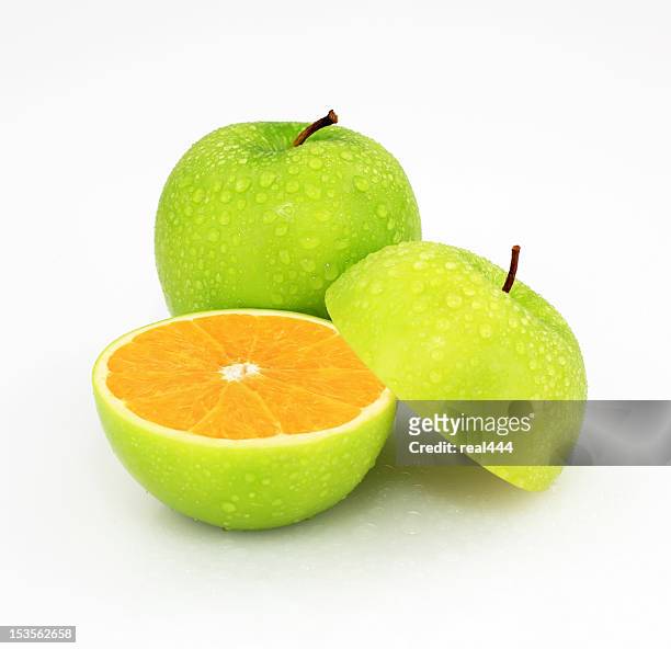 apple or orange - green apple slices stock pictures, royalty-free photos & images