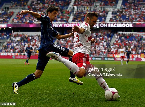 Brandon Barklage of New York Red Bulls fights for the ball with Alvaro Fernandez of Chicago Fire during their match at Red Bull Arena on October 6,...