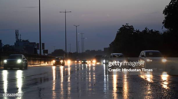 Commuters travel amid light rain on National Highway-48 near Mini Secretariat, on July 16, 2023 in Gurugram, India.
