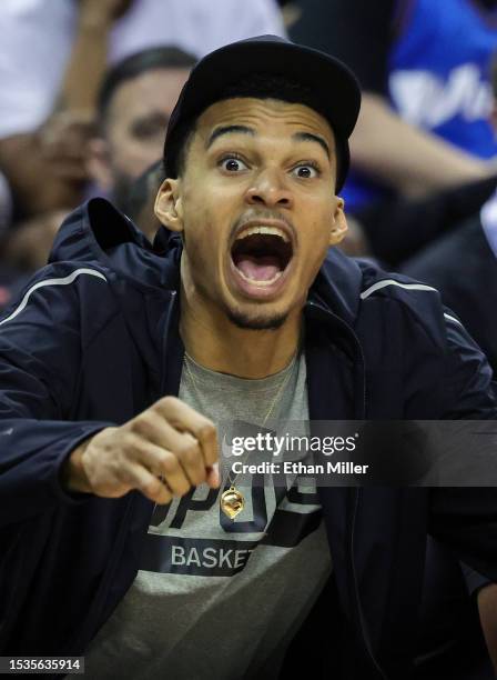 Victor Wembanyama of the San Antonio Spurs reacts on the bench as his teammate Blake Wesley dunks against the Washington Wizards in the second half...