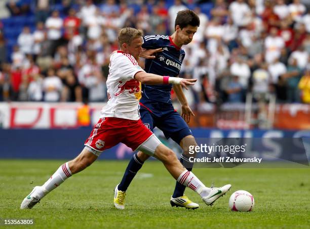 Jan Gunnar Solli of New York Red Bulls fights for the ball with Alvaro Fernandez of Chicago Fire during their match at Red Bull Arena on October 6,...