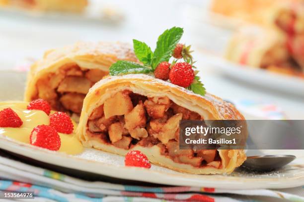 two pieces of apple strudel, pudding, wild strawberries - raisin cake stock pictures, royalty-free photos & images