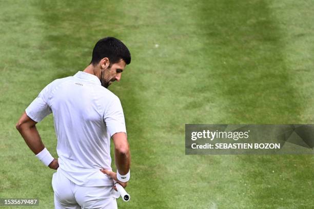 Serbia's Novak Djokovic reacts as he plays against Spain's Carlos Alcaraz during their men's singles final tennis match on the last day of the 2023...