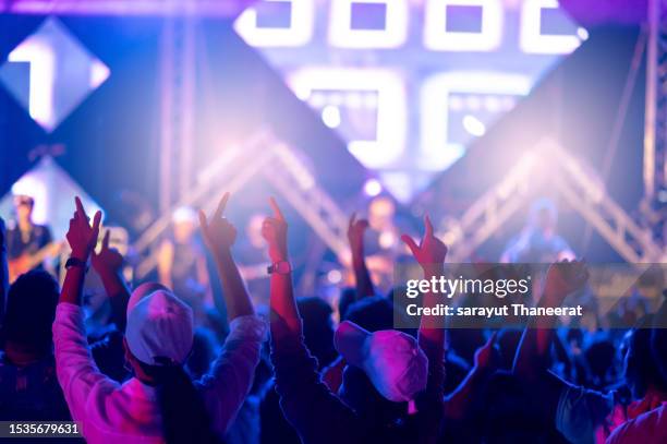 people raising hands super fun with a concert in front of the performance stage. - club dj stock-fotos und bilder