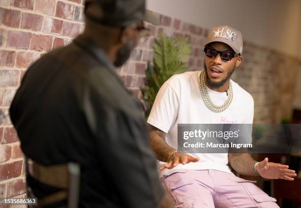 Artist Lah Pat speaks on stage during the Madd Hatta live podcast show at The Greasy Spoon Soulfood Bistro on July 11, 2023 in Pearland, Texas.