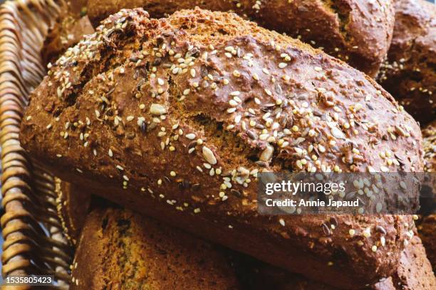 seeded brown bread loaf close up - brown bread stock pictures, royalty-free photos & images