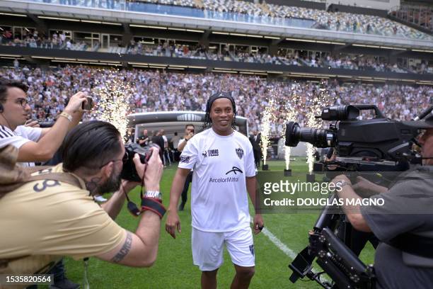 Brazilian ex-football star Ronaldinho Gaucho is pictured before the start of the "Lendas do Galo" match at Arena MRV, the first game at Atletico...