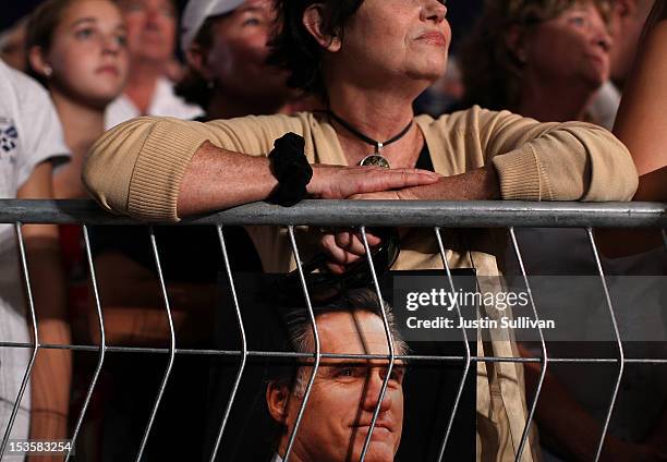 Supporter holds a photograph of Republican presidential candidate, former Massachusetts Gov. Mitt Romney during a campaign rally on October 6, 2012...