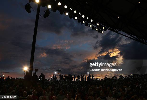 Members of the media stand on a press riser as storm clouds move by during a campaign event for Republican presidential candidate, former...