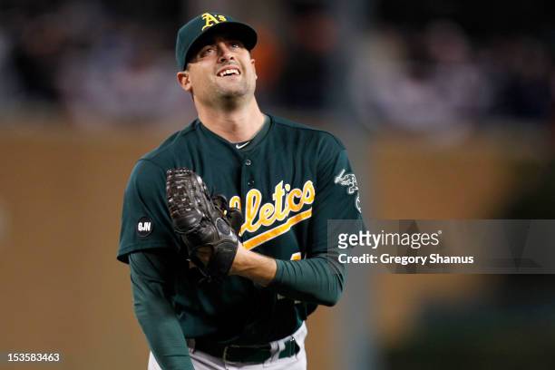 Pat Neshek of the Oakland Athletics looks to the sky as he touches the patch with the letter's "GJN" on it after he recorded the final out of the...
