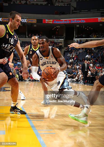 Mike Conley of the Memphis Grizzlies drives against Mirza Begic of Real Madrid on October 6, 2012 at FedExForum in Memphis, Tennessee. NOTE TO USER:...
