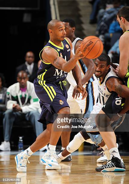 Dontaye Draper of Real Madrid passes the ball against Mike Conley of the Memphis Grizzlies on October 6, 2012 at FedExForum in Memphis, Tennessee....