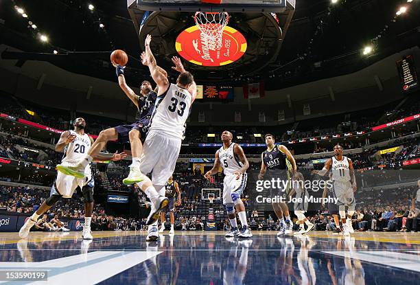 Rudy Fernandez of Real Madrid goes to the basket against Marc Gasol of the Memphis Grizzlies on October 6, 2012 at FedExForum in Memphis, Tennessee....