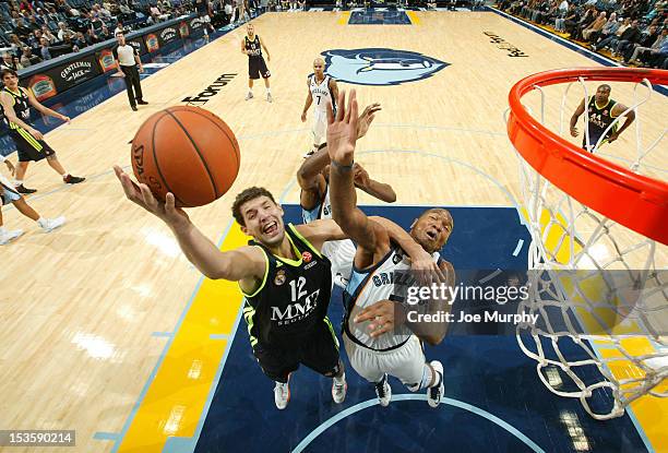 Nikola Mirotic of Real Madrid shoots against Marreese Speights of the Memphis Grizzlies on October 6, 2012 at FedExForum in Memphis, Tennessee. NOTE...