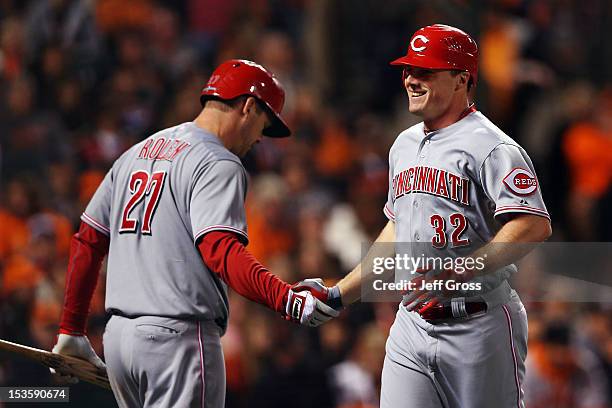 Jay Bruce of the Cincinnati Reds celebrates with teammate Todd Frazier after hitting a solo home run in the fourth inning against the San Francisco...