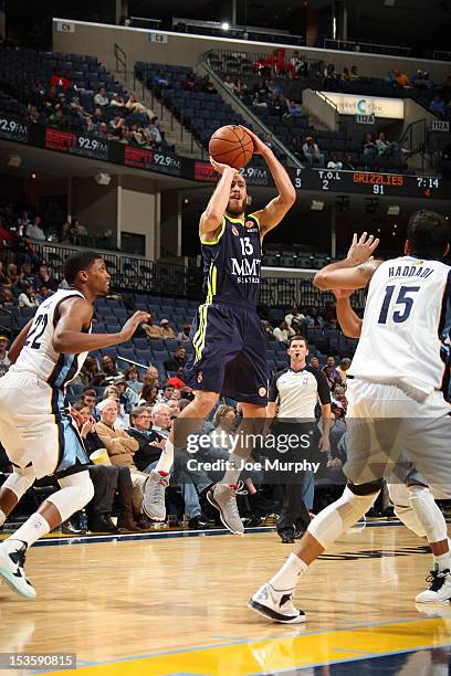 Sergio Rodriquez of Real Madrid shoots against Rudy Gay and Hamed Haddadi of the Memphis Grizzlies on October 6, 2012 at FedExForum in Memphis,...