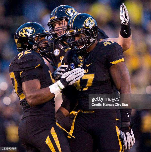 Missouri Tigers defensive lineman Kony Ealy is congratulated by teammates Michael Sam and Matt Hoch , after Ealy sacked Vanderbilt Commodores...