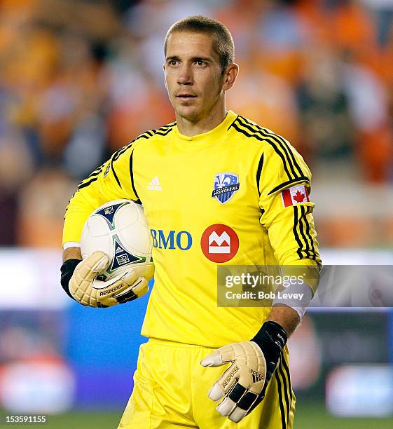 Troy Perkins of the Montreal Impact looks over at the linesman after Brian Ching of the Houston Dynamo had scored the go ahead goal in extra time at...