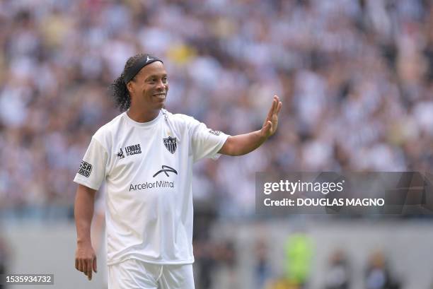 Brazilian ex-football star Ronaldinho Gaucho gestures during the "Lendas do Galo" match at Arena MRV, the first game at Atletico Mineiro's new...