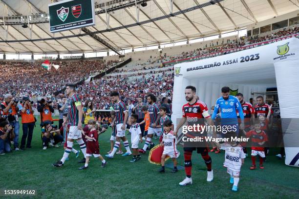 Everton Ribeiro of Flamengo leads the teams to the pitch prior a match between Fluminense and Flamengo as part of Brasileirao 2023 at Maracana...