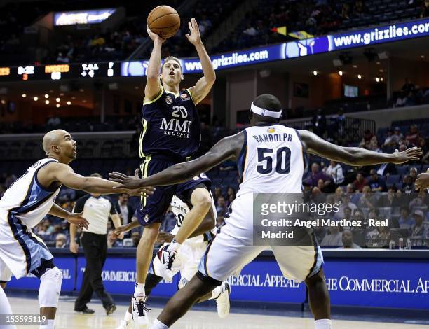 Jaycee Carroll of Real Madrid goes to the basket against Zach Randolph and Jerryd Bayless of the Memphis Grizzlies during the Euroleague American...