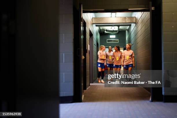 Katie Robinson, Lucy Bronze, Katie Zelem and Laura Coombs of England walk out prior to a training session at the Sunshine Coast Stadium on July 12,...