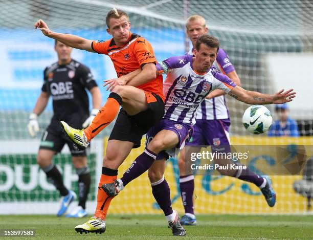 Besart Berisha of the Roar and Liam Miller of the Glory contest for the ball during the round one A-League match between the Perth Glory and the...