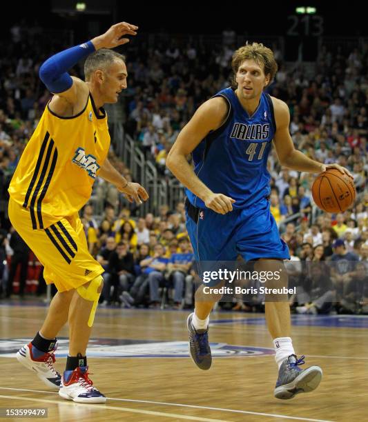 Dirk Nowitzki of Dallas vies for the ball with Sven Schultze of Berlin during the NBA Europe Live 2012 Tour match between Alba Berlin and Dallas...