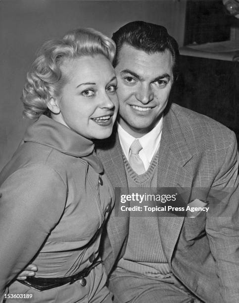 English actress and singer Diana Coupland with singer and composer Monty Norman in London, after the couple announced their engagement, 26th November...