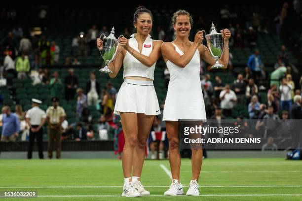Taiwan's Hsieh Su-wei and Czech Republic's Barbora Strycova hold their trophies after beating Australia's Storm Hunter and Belgium's Elise Mertens,...