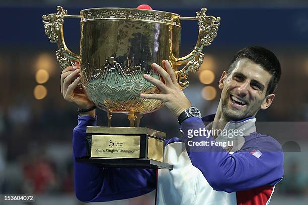 Novak Djokovic of Serbia poses for photographers after defeqating Jo-Wilfried Tsonga of France during the Men's Single Final of the China Open at the...