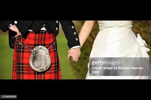 wedding scottish groom and bride holding hands - kult stock pictures, royalty-free photos & images