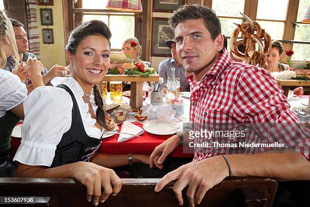 Mario Gomez of FC Bayern Muenchen attends with Silvia Meichel the Oktoberfest beer festival at the Kaefer Wiesnschaenke tent on October 7, 2012 in...
