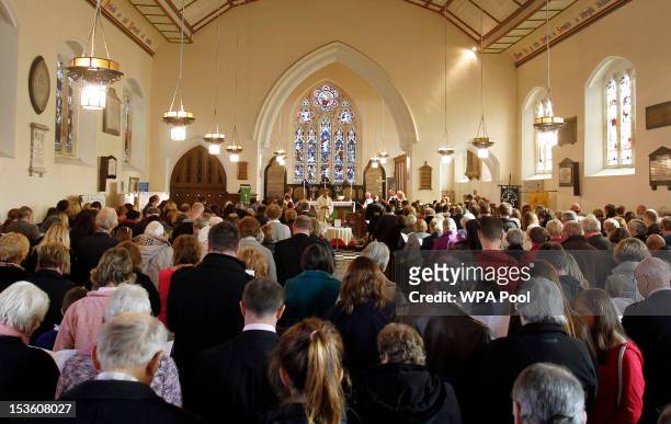 Members of the community of Machynlleth attend a Sunday church service at St Peter's Church for missing five-year-old April Jones on October 7, 2012...