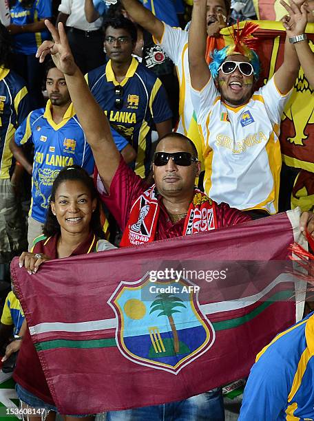 West Indies cricket supporters wave national flags ahead of the ICC Twenty20 Cricket World Cup's final match between Sri Lanka and West Indies at the...