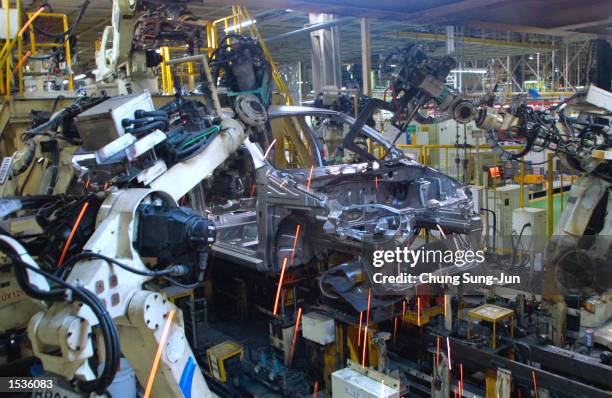 Robots assemble a new GM Daewoo vehicle, the KALOS, at the Bupyung plant October 28, 2002 in Inchon, west of Seoul, South Korea. GM formally launched...