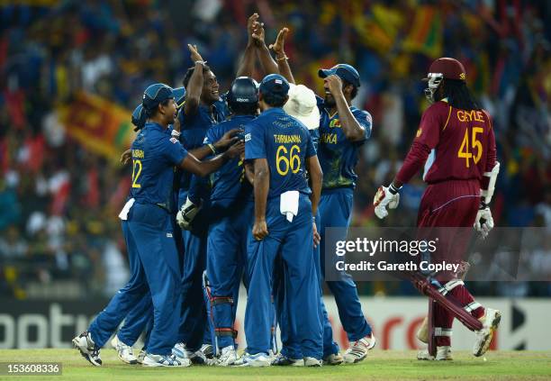 Ajantha Mendis of Sri Lanka celebrates with teammates after dismissing Chris Gayle of the West Indies during the ICC World Twenty20 2012 Final...