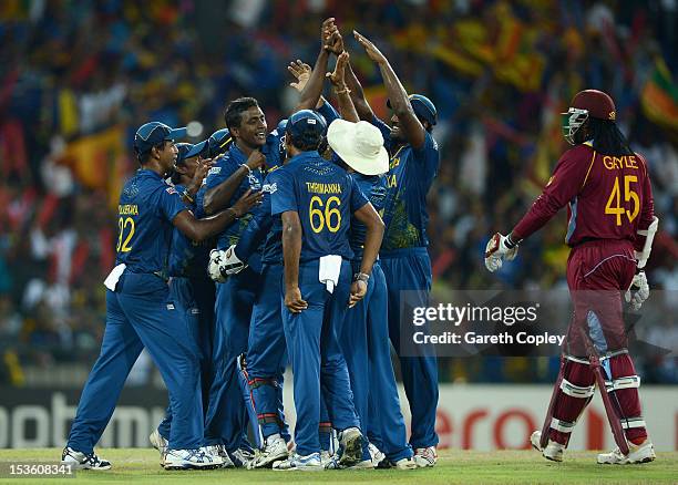 Ajantha Mendis of Sri Lanka celebrates with teammates after dismissing Chris Gayle of the West Indies during the ICC World Twenty20 2012 Final...