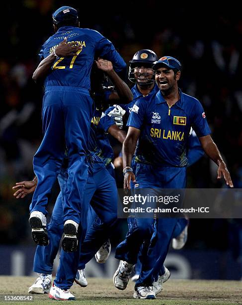 Ajantha Mendis of Sri Lanka celebrates with his captain Mahela Jayawardene after trapping Chris Gayle of West Indies LBW during the ICC World...