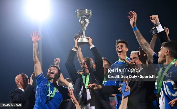 Italy head coach Alberto Bollini lifts the trophy after the UEFA European Under-19 Championship 2022/23 final match between Portugal and Italy at the...
