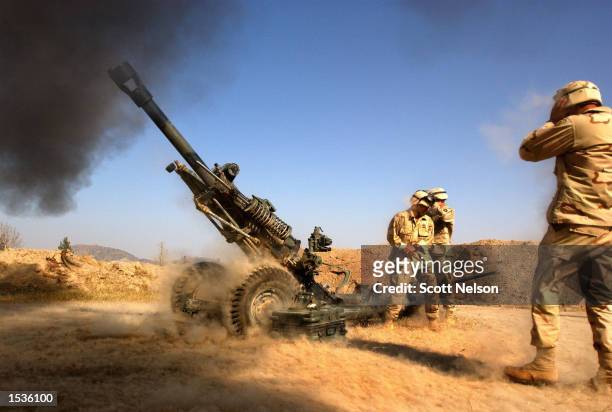 Members of the U.S. Army C company battery 1/319 Airborne Field Artillery unit, 82nd Airborne, fire a 105-mm Howitzer during a live fire exercise...