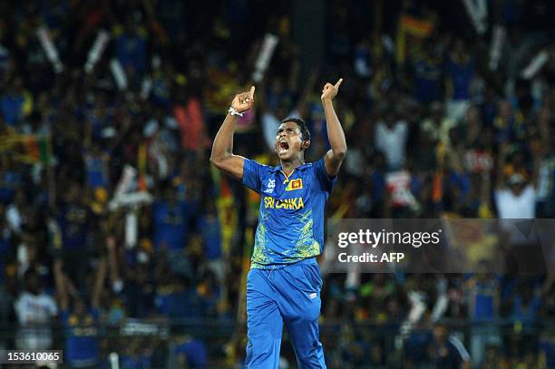 Sri Lankan cricketer Ajantha Mendis celebrates the dismissal of West Indies cricketer Dwayne Bravo during the ICC Twenty20 Cricket World Cup's final...