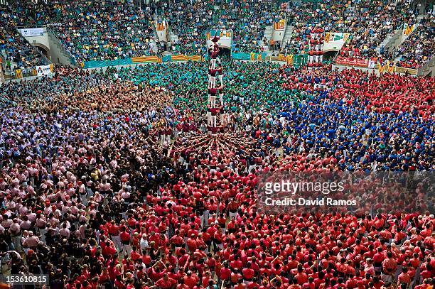 Members of the Colla 'Castellers de Lleida' climb up as they construct a human tower during the 24th Tarragona Castells Comptetion on October 7, 2012...