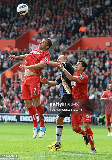 Rickie Lambert of Southampton gets above Brede Hangeland of Fulham and team mate Jose Fonte during the Barclays Premier League match between...